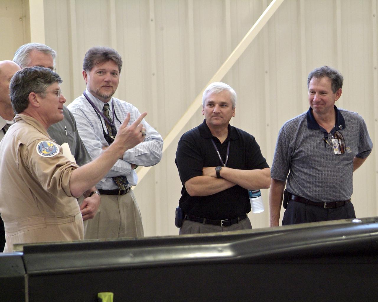 NASA Dryden research pilot Jim Smolka (left) details a recent flight experiment on a modified F-15B research aircraft to test range program manager Jerry McKee, center director Kevin Petersen and NASA Administrator Michael Griffin (right) during Griffin's initial visit to NASA's Dryden Flight Research Center on Tuesday, May 24.