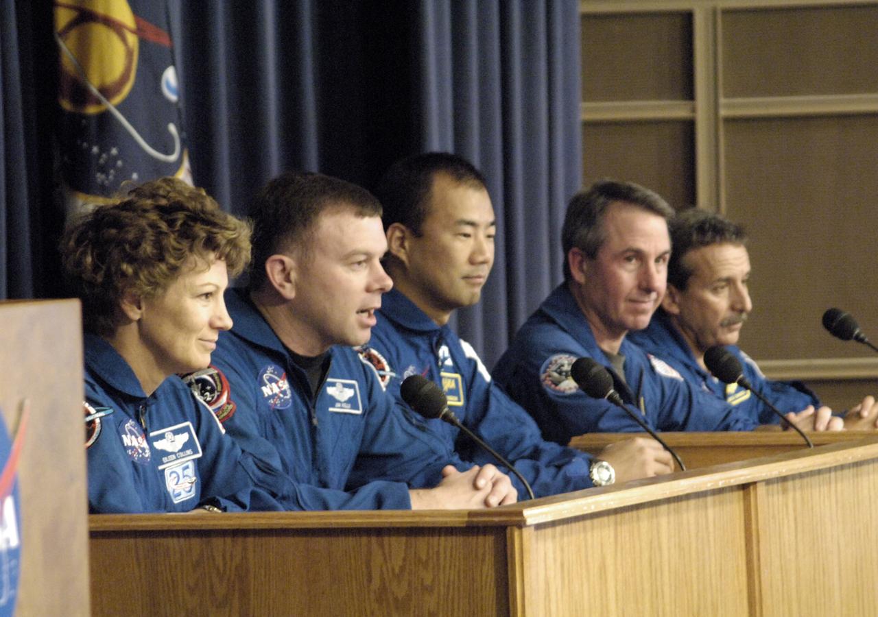 Pilot James Kelly answered a question at a briefing following the successful landing of the Space Shuttle Discovery at NASA DFRC on August 9, 2005. Commander Eileen Collins is on his right, mission specialists Soichi Noguchi, Andrew Thomas and Charles Camarda are to his left. Space Shuttle Discovery landed safely at NASA's Dryden Flight Research Center at Edwards Air Force Base in California at 5:11:22 a.m. PDT this morning, following the very successful 14-day STS-114 return to flight mission.  During their two weeks in space, Commander Eileen Collins and her six crewmates tested out new safety procedures and delivered supplies and equipment the International Space Station.  Discovery spent two weeks in space, where the crew demonstrated new methods to inspect and repair the Shuttle in orbit. The crew also delivered supplies, outfitted and performed maintenance on the International Space Station. A number of these tasks were conducted during three spacewalks.  In an unprecedented event, spacewalkers were called upon to remove protruding gap fillers from the heat shield on Discovery's underbelly. In other spacewalk activities, astronauts installed an external platform onto the Station's Quest Airlock and replaced one of the orbital outpost's Control Moment Gyroscopes.  Inside the Station, the STS-114 crew conducted joint operations with the Expedition 11 crew. They unloaded fresh supplies from the Shuttle and the Raffaello Multi-Purpose Logistics Module. Before Discovery undocked, the crews filled Raffeallo with unneeded items and returned to Shuttle payload bay.  Discovery launched on July 26 and spent almost 14 days on orbit.