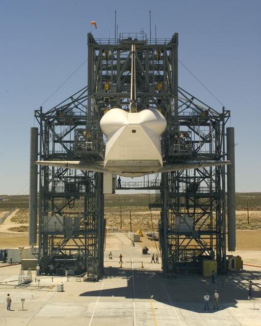 NASA image: NASA's Space Shuttle Discovery is raised to allow ample clearance for the modified 747 Shuttle Carrier Aircraft to position underneath for attachment