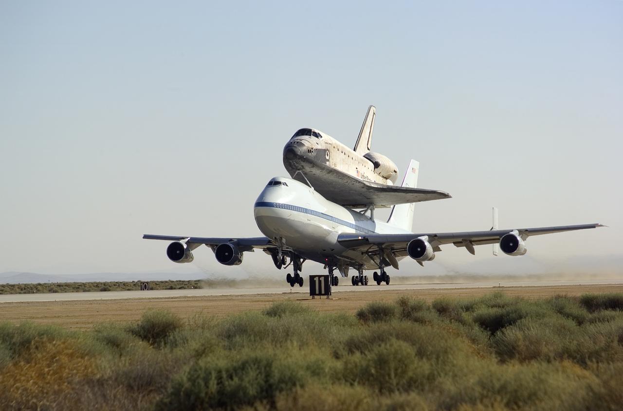 NASA's modified Boeing 747 Shuttle Carrier Aircraft with the Space Shuttle Discovery on top lifts off from Edwards Air Force Base to begin its ferry flight back to the Kennedy Space Center in Florida. The cross-country journey will take two days, with stops at several intermediate points for refueling. Space Shuttle Discovery landed safely at NASA's Dryden Flight Research Center at Edwards Air Force Base in California at 5:11:22 a.m. PDT, August 9, 2005, following the very successful 14-day STS-114 return to flight mission.  During their two weeks in space, Commander Eileen Collins and her six crewmates tested out new safety procedures and delivered supplies and equipment the International Space Station.  Discovery spent two weeks in space, where the crew demonstrated new methods to inspect and repair the Shuttle in orbit. The crew also delivered supplies, outfitted and performed maintenance on the International Space Station. A number of these tasks were conducted during three spacewalks.  In an unprecedented event, spacewalkers were called upon to remove protruding gap fillers from the heat shield on Discovery's underbelly. In other spacewalk activities, astronauts installed an external platform onto the Station's Quest Airlock and replaced one of the orbital outpost's Control Moment Gyroscopes.  Inside the Station, the STS-114 crew conducted joint operations with the Expedition 11 crew. They unloaded fresh supplies from the Shuttle and the Raffaello Multi-Purpose Logistics Module. Before Discovery undocked, the crews filled Raffeallo with unneeded items and returned to Shuttle payload bay.  Discovery launched on July 26 and spent almost 14 days on orbit.