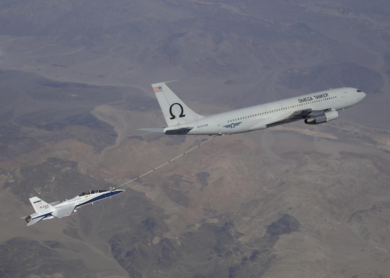 F/A-18 #845 behind an Omega Air Boeing 707 tanker during an Autonomous Airborne Refueling Demonstration (AARD) flight.