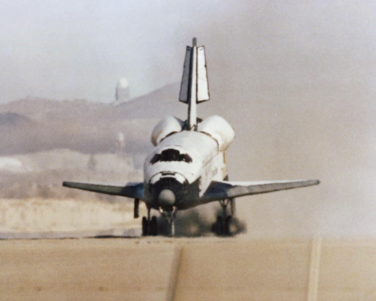 The Space Shuttle Columbia touches down on lakebed runway 23 at Edwards Air Force Base, Calif., to conclude the first orbital shuttle mission.