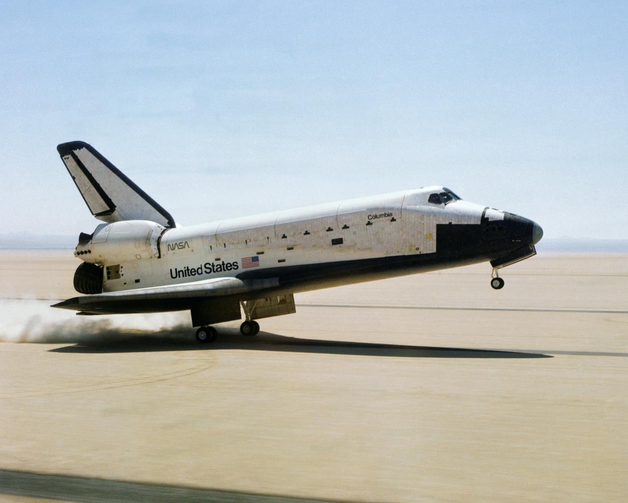 The Space Shuttle Columbia touches down on lakebed runway 23 at Edwards Air Force Base, Calif., to conclude the first orbital shuttle mission. (JSC photo # S81-30734)