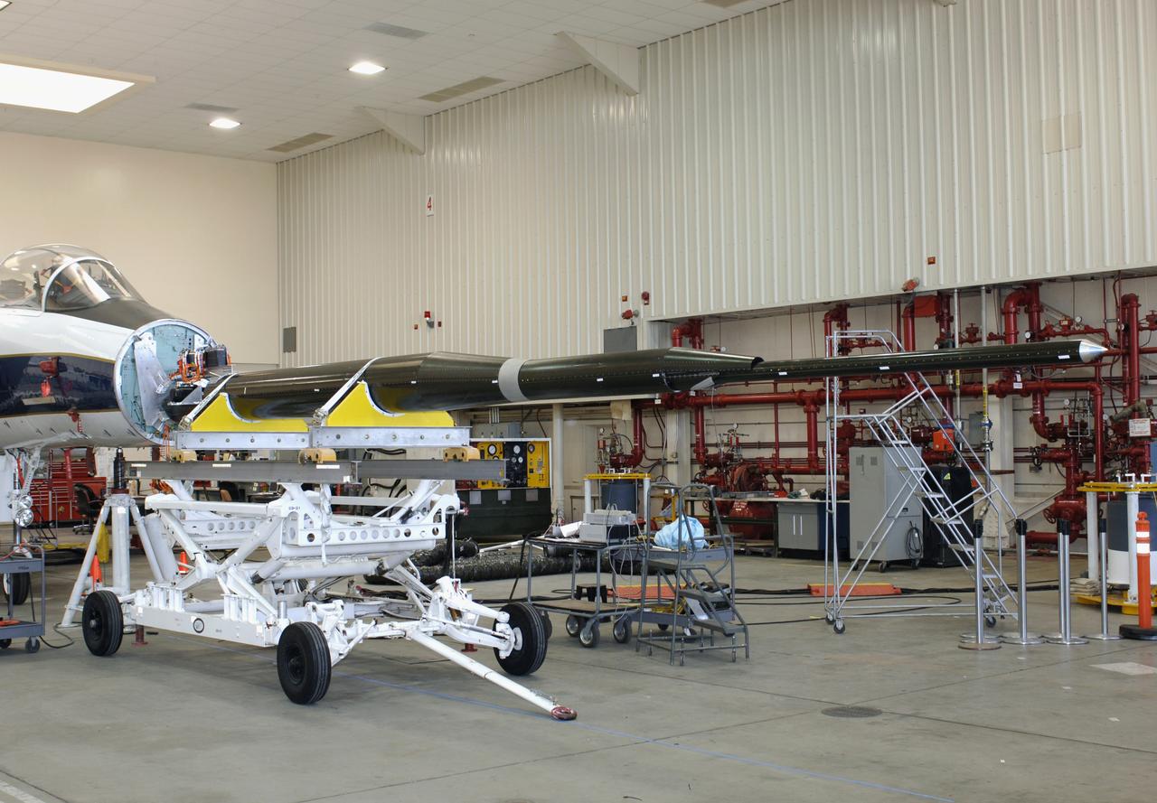 Gulfstream's Quiet Spike sonic boom mitigator being installed on NASA DFRC's F-15B testbed aircraft. The project seeks to verify the structural integrity of the multi-segmented, articulating spike attachment designed to reduce and control a sonic boom.