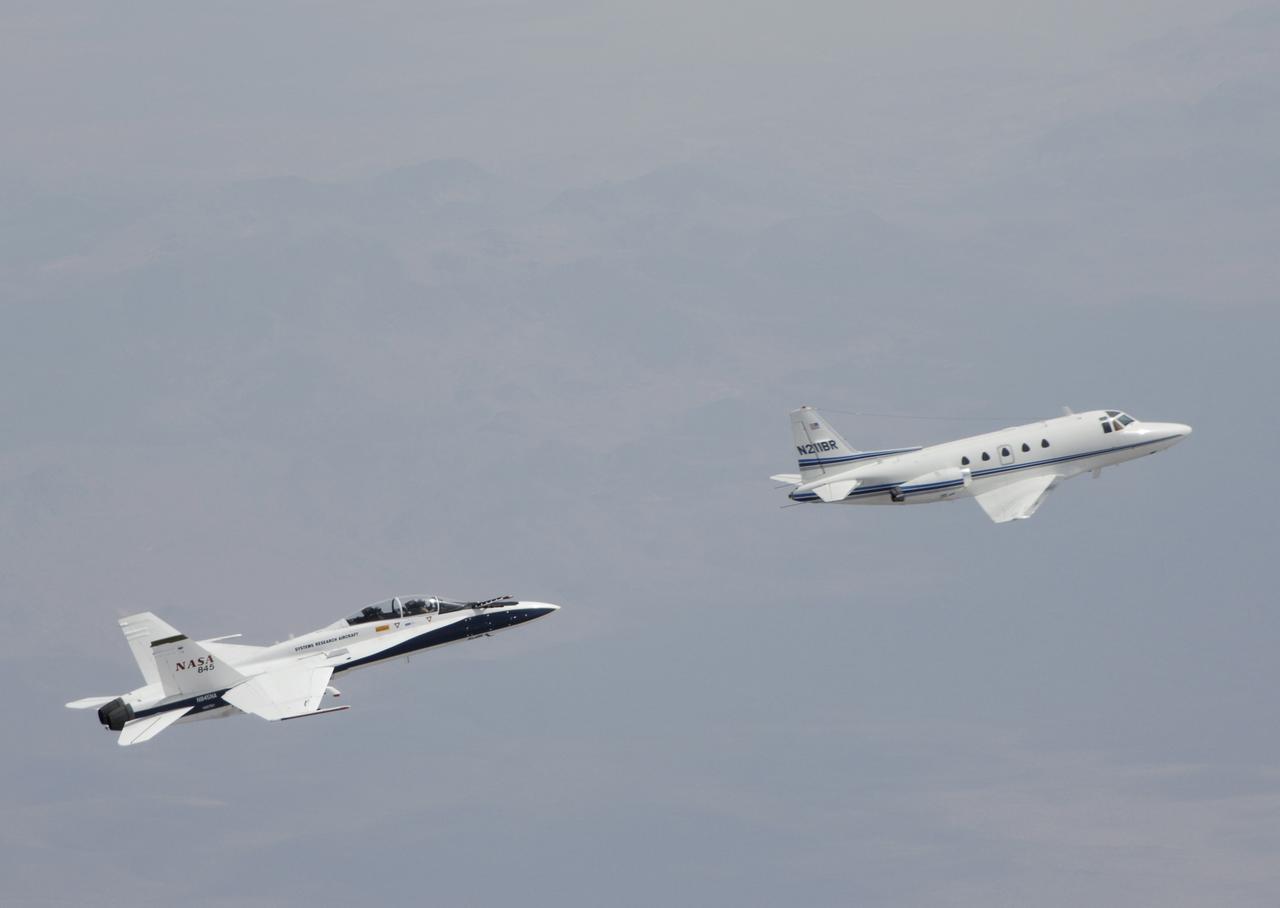 Testing autonomous software for AARD program using a NASA F/A-18 #845 following a chartered Sabreliner.