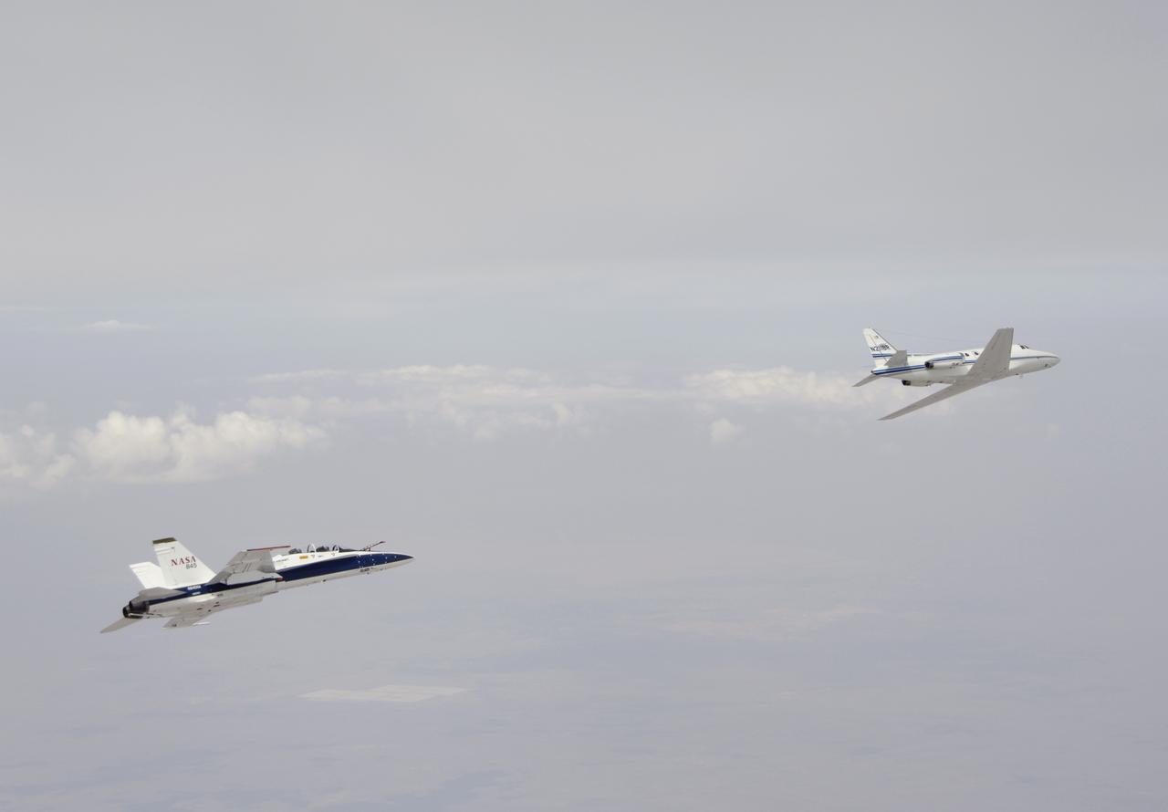 Testing autonomous software for AARD program using a NASA F/A-18 #845 following a chartered Sabreliner.