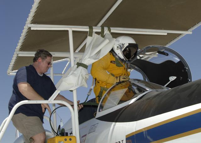 NASA image: NASA Dryden life support technician Jim Sokolik assists pressure-suited pilot Dee Porter into the cockpit of NASA's ER-2 Earth resources aircraft.
