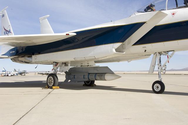 An inert Phoenix missile nestled under the fuselage of NASA Dryden's F-15B aircraft is being studied as a possible test vehicle to obtain hypersonic data.