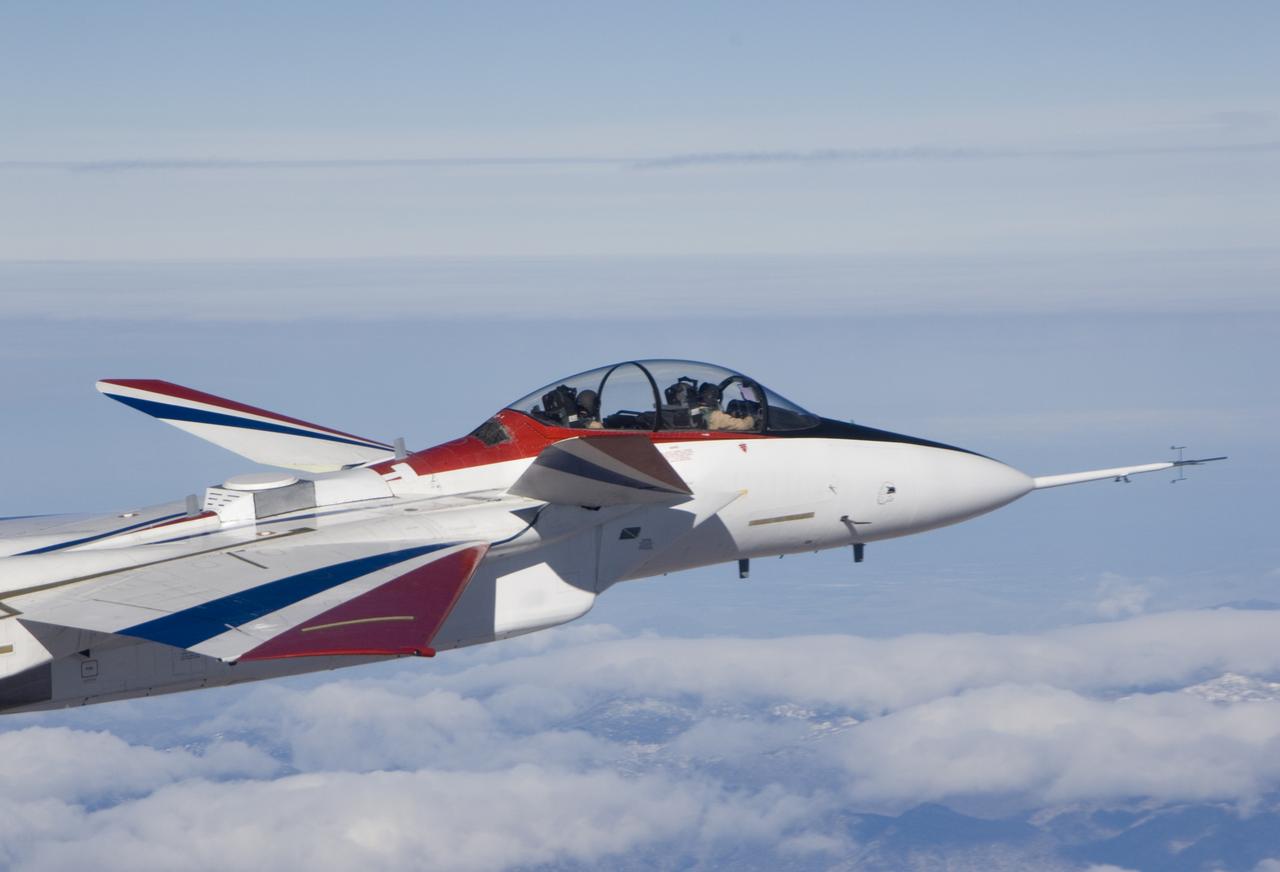 Range safety and phased-array range user system antennas validated in the ECANS project can be seen just behind the cockpit on NASA's NF-15B research aircraft.