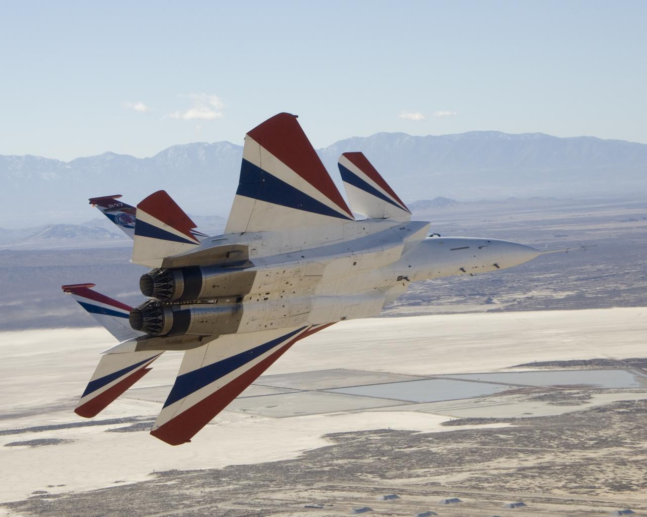 Two small Range Safety System antennas are located just behind the engine inlets of NASA's NF-15B research aircraft as it banks away from the chase plane.