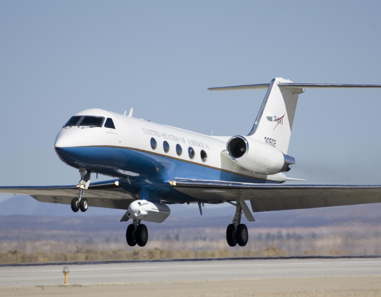 NASA's Gulfstream-III research testbed lifts off the Edwards AFB runway on an envelope-expansion flight test with the UAV synthetic aperture radar pod.