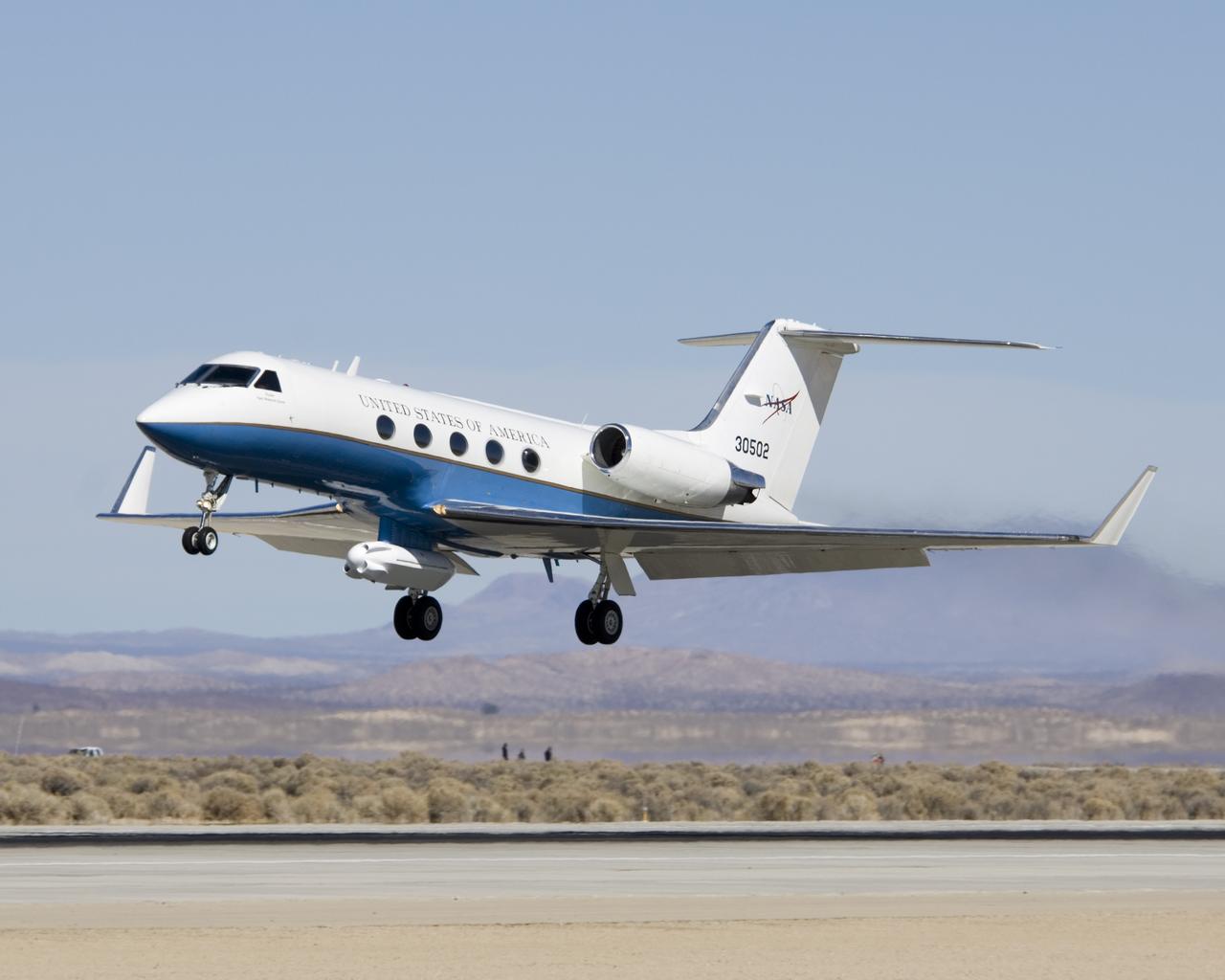 An eight-foot-long pod designed to carry a synthetic aperture radar hangs from the underbelly of NASA's Gulfstream-III research testbed.