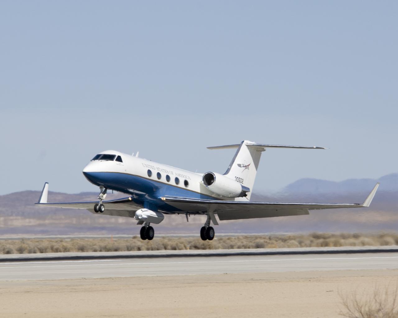 NASA's Gulfstream-III research testbed lifts off from Edwards AFB on a checkout test flight with the UAV synthetic aperture radar pod under its belly.
