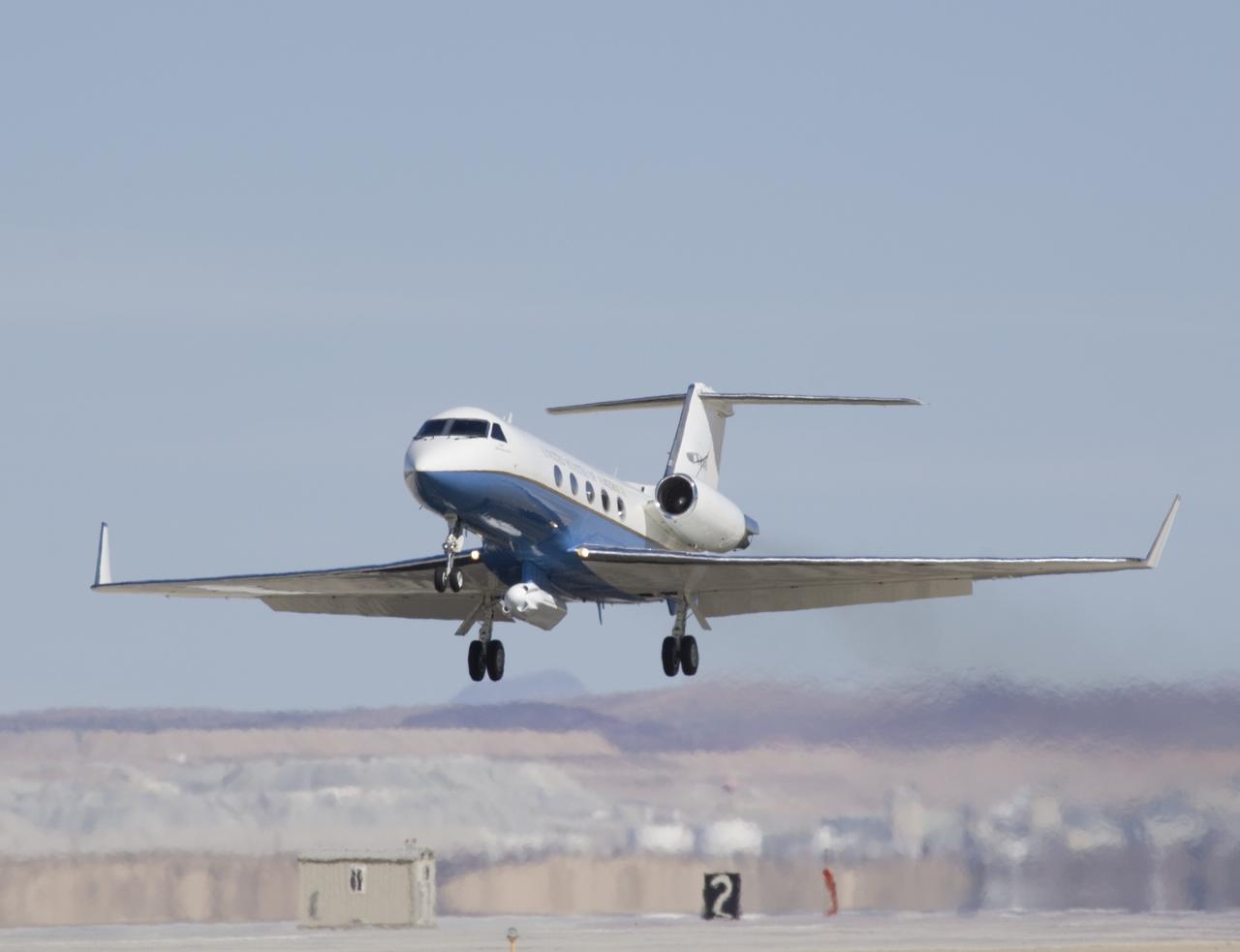 Shimmering heat waves trail behind NASA's Gulfstream-III research aircraft as it departs the Edwards AFB runway on a UAVSAR pod checkout test flight.
