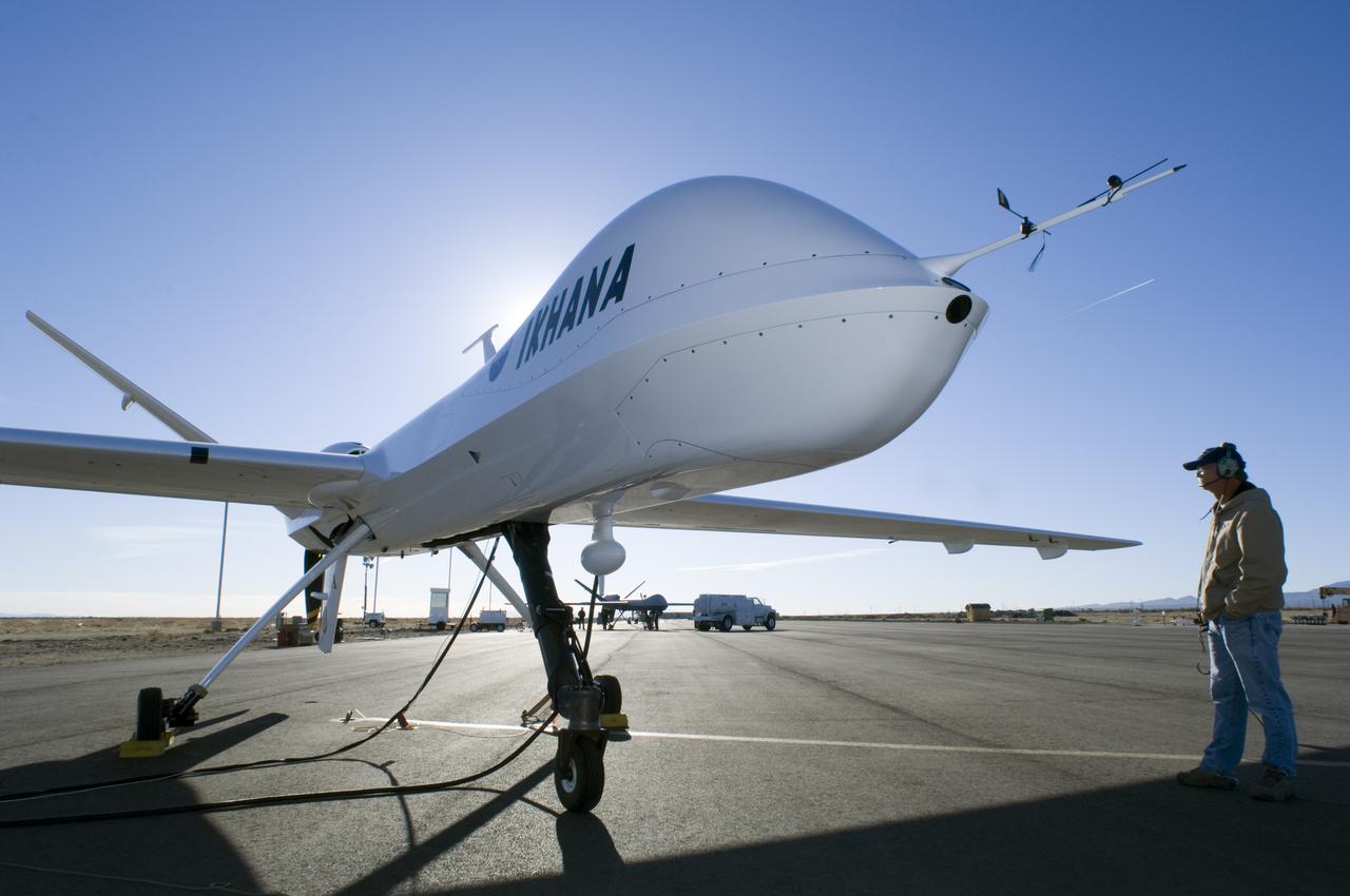 Silhouetted by the morning sun, NASA's Ikhana, a civil version of the Predator B unmanned aircraft, is readied for flight By NASA Dryden crew chief Joe Kinn.