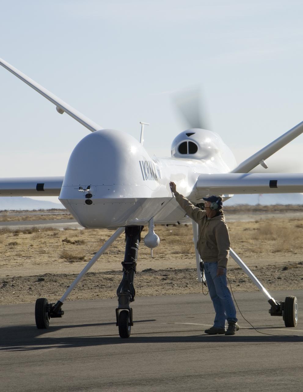 Crew chief Joe Kinn gives NASA's Ikhana unmanned aircraft a final check during engine run-up prior to takeoff at General Atomics Aeronautical Systems' airfield.