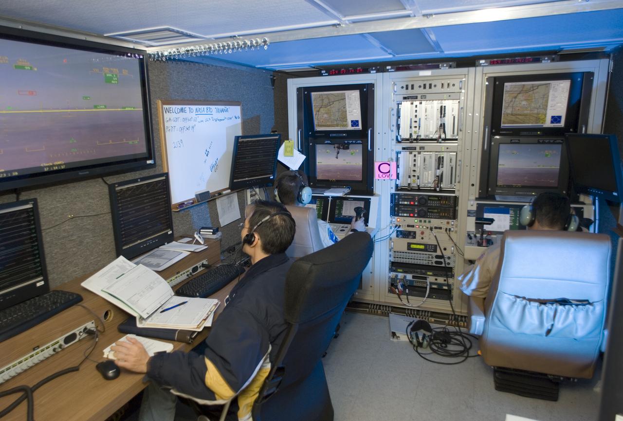 NASA's Ikhana unmanned science aircraft ground control station includes consoles for two pilots and positions for scientists and engineers along the side.