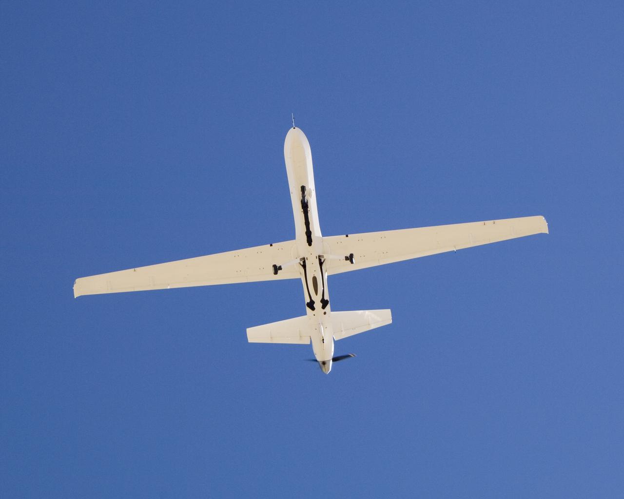 The narrow fuselage of NASA'S Ikhana unmanned science aircraft, a civil version of General Atomics' Predator B, is evident in this view from underneath.