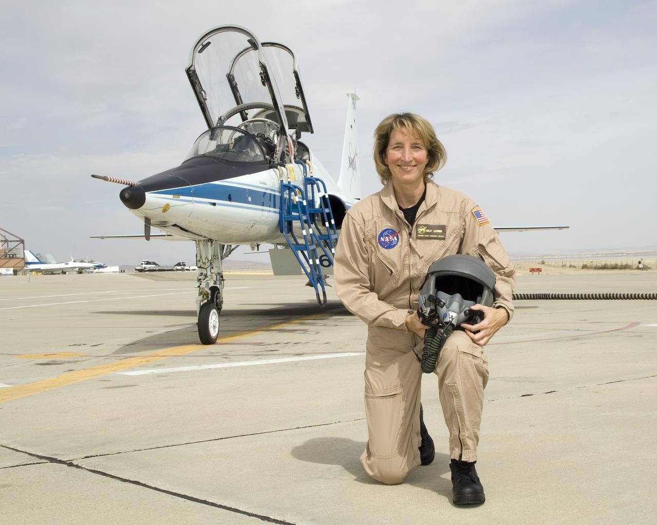 Kelly Latimer is a research pilot in the Flight Crew Branch of NASA's Dryden Flight Research Center, Edwards, Calif. Latimer joined NASA in March 2007 and will fly the T38, T-34, G-III, C-17 and the "Ikhana" Predator B. Latimer is Dryden's first female research test pilot. Prior to joining NASA, Latimer was on active duty with the U.S. Air Force. She has accumulated more than 5,000 hours of military and civilian flight experience in 30 aircraft.  Latimer's first association with NASA was while attending graduate school at George Washington University, Washington, D.C. Her studies included work with the Joint Institute for the Advancement of Flight Sciences at NASA's Langley Research Center, Hampton, Va.  She flew an Air Force C-17 during a 2005 NASA study to reduce aircraft noise. A team of California Polytechnic State University students and Northrop Grumman personnel were stationed on Rogers Dry Lake located at Edwards Air Force Base, Calif., to record the noise footprint of the aircraft as it made various landing approaches to Edwards' runway.  Latimer completed undergraduate pilot training at Reese Air Force Base, Texas, in 1990. She remained at Reese as a T-38 instructor pilot until 1993. She was assigned as a C-141 aircraft commander at McCord Air Force Base, Tacoma, Wash., until 1996.  Latimer graduated from the U.S. Air Force Test Pilot School at Edwards in Class 96B. She served as a C-17 and C-141 experimental test pilot at Edwards until 2000. She then became the chief of the Performance Branch and a T-38 instructor pilot at The Air Force Test Pilot School.  She returned to McCord in 2002, where she was a C-17 aircraft commander and the operations officer for the 62nd Operations Support Squadron. In 2004, Latimer became the commander of Edwards' 418th Flight Test Squadron and director of the Global Reach Combined Test Force. Following that assignment, she deployed to Iraq as an advisor to the Iraqi Air Force. Her last active duty tour was as an instructor a
