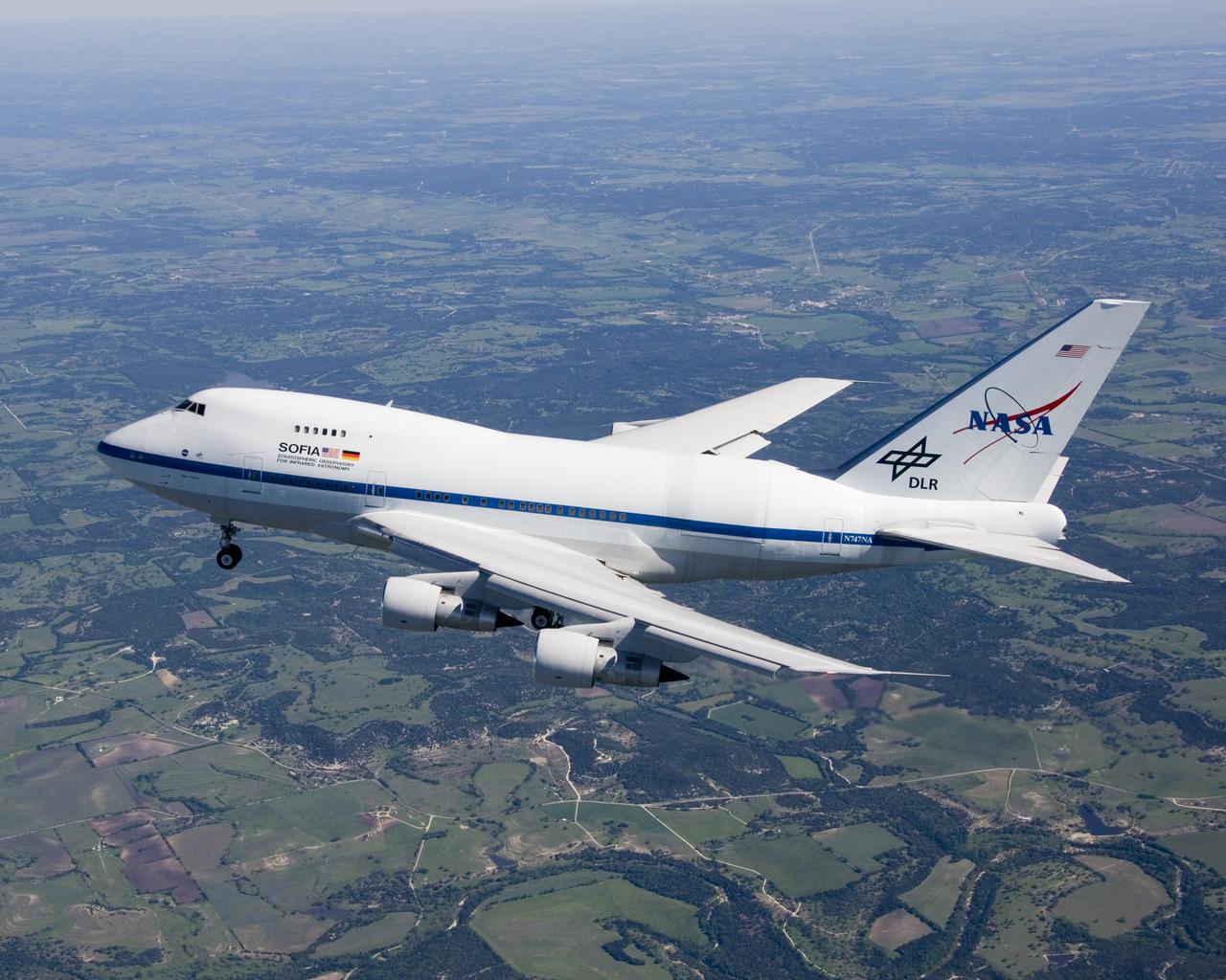 Christened "Clipper Lindbergh" when it flew for Pan American Airways in the 1970s, the SOFIA 747SP shows evidence of modification to its aft fuselage contours to accommodate a 16-foot-tall opening for a 45,000-pound infrared telescope. This inflight photo was taken on SOFIA's first flight since its modification to become an airborne observatory.