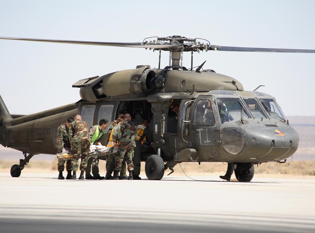 Air Force rescue team members load the volunteer "injured astronaut" on a stretcher into a Blackhawk helicopter for evacuation to a hospital during the exercise. (USAF photo # 070505-F-1287F-166)