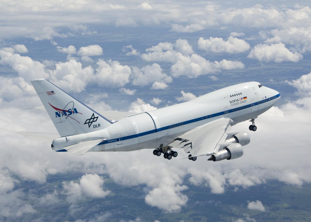 NASA's Boeing 747SP SOFIA airborne observatory soars over a bed of puffy clouds during its second checkout flight over the Texas countryside on May 10, 2007.
