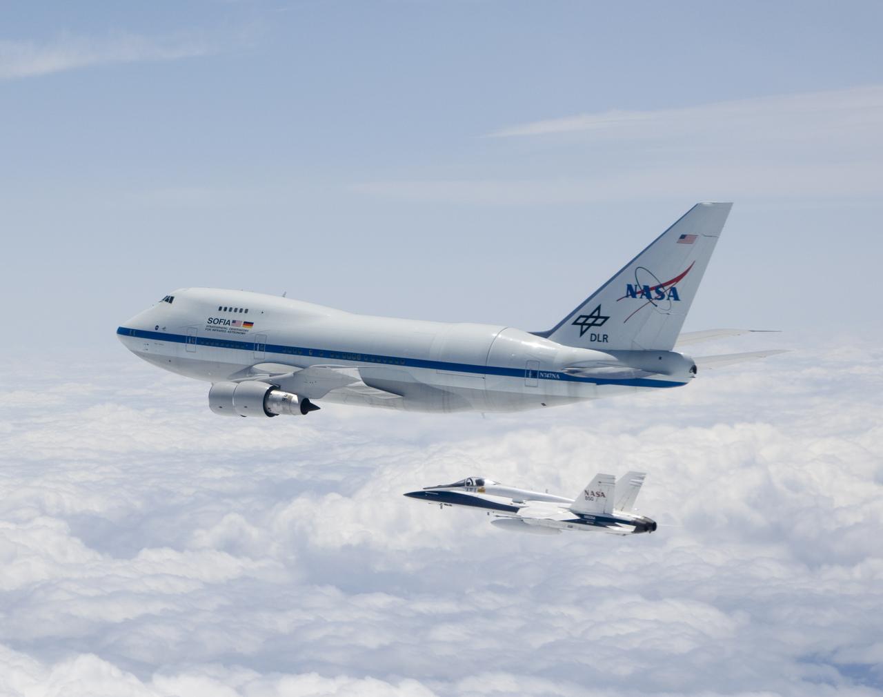 NASA's SOFIA airborne observatory is shadowed by a NASA F/A-18 safety chase aircraft during its second checkout flight near Waco, Texas on May 10, 2007.
