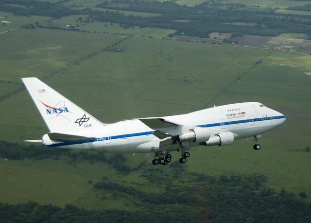 NASA image: NASA's highly modified Boeing 747SP SOFIA observatory banks low over the Texas countryside as it heads for landing at Waco to conclude its second check flight
