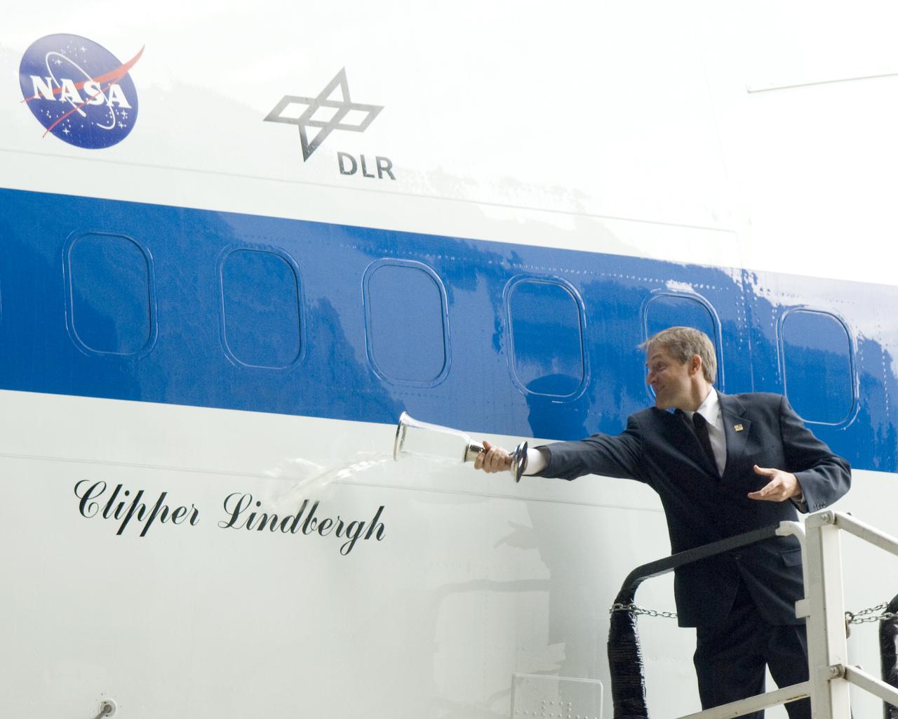Erik Lindbergh christens NASA's 747 Clipper Lindbergh, the Stratospheric Observatory for Infrared Astronomy, with a special commemorative concoction representing local, NASA, and industry partners. The liquid consisted of a small amount of California wine representing NASA Dryden where the aircraft will be stationed, a small amount of Dr. Pepper (a Waco, TX invention), a quantity of French bottled water (to symbolize Charles Lindbergh's flight to Paris on this date), and a dash of German beer to represent the SOFIA German industry partners.