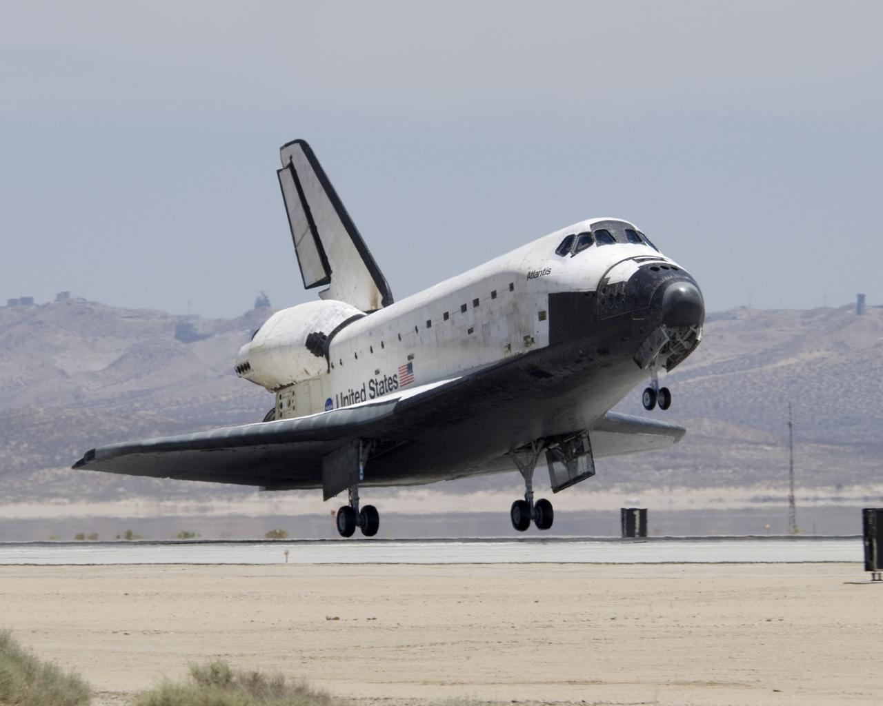 The Space Shuttle Atlantis touches down at Edwards AFB on June 22, 2007, to conclude International Space Station construction and supply mission STS-117.