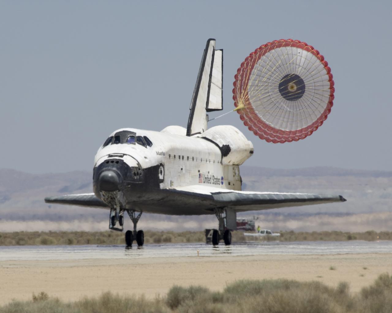 The Space Shuttle Atlantis' drag chute deploys as it rolls out on Runway 22 at Edwards AFB at the conclusion of its 13-day STS-117 mission to the ISS.