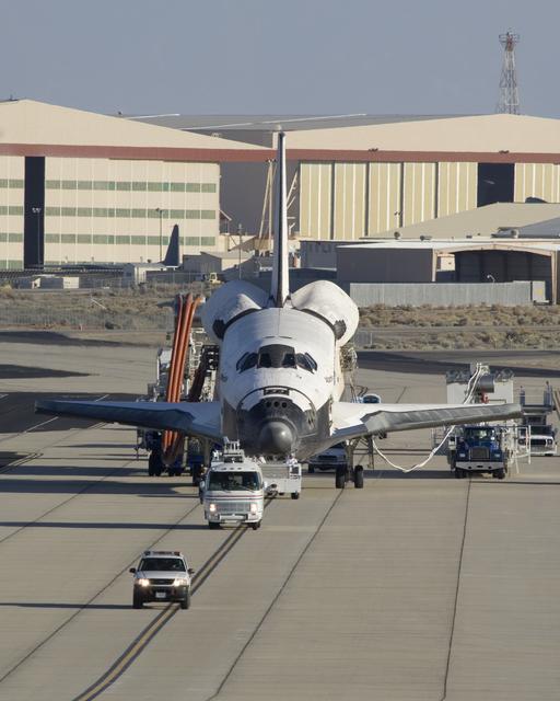 NASA image: Accompanied by a convoy of recovery vehicles, the Space Shuttle Atlantis is towed up the taxiway at NASA Dryden following its landing on June 22, 2007