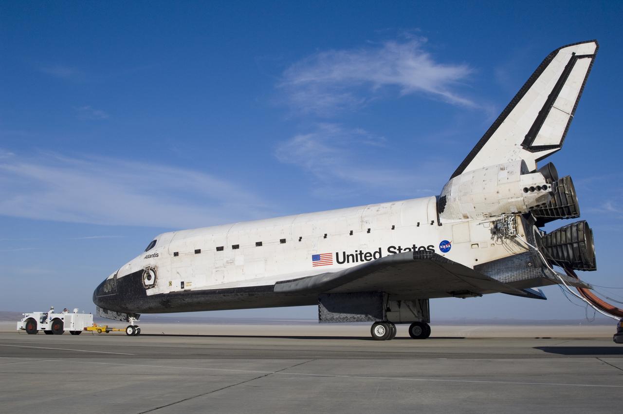 Following its landing on June 22, 2007, the Space Shuttle Atlantis is towed from the runway at Edwards Air Force Base to NASA Dryden's Mate-Demate Device (MDD) for post-flight processing in preparation for its return to the Kennedy Space Center in Florida.