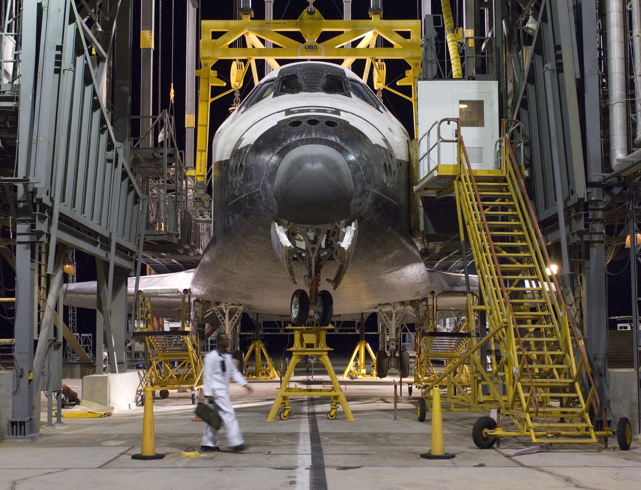 The Space Shuttle Atlantis receives post-flight servicing in the Mate-Demate Device (MDD), following its landing at NASA's Dryden Flight Research Center, Edwards, California, June 22, 2007. The gantry-like MDD structure is used for servicing the shuttle orbiters in preparation for their ferry flight back to the Kennedy Space Center in Florida, including mounting the shuttle atop NASA's modified Boeing 747 Shuttle Carrier Aircraft.