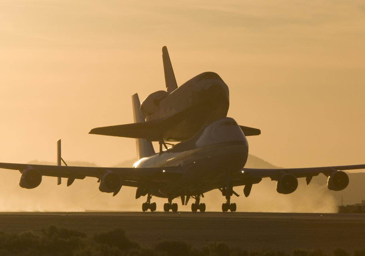 NASA's modified Boeing 747 Shuttle Carrier Aircraft with the Space Shuttle Atlantis on top lifts off from Edwards Air Force Base to begin its ferry flight back to the Kennedy Space Center in Florida. The cross-country journey will take approximately two days, with stops at several intermediate points for refueling.