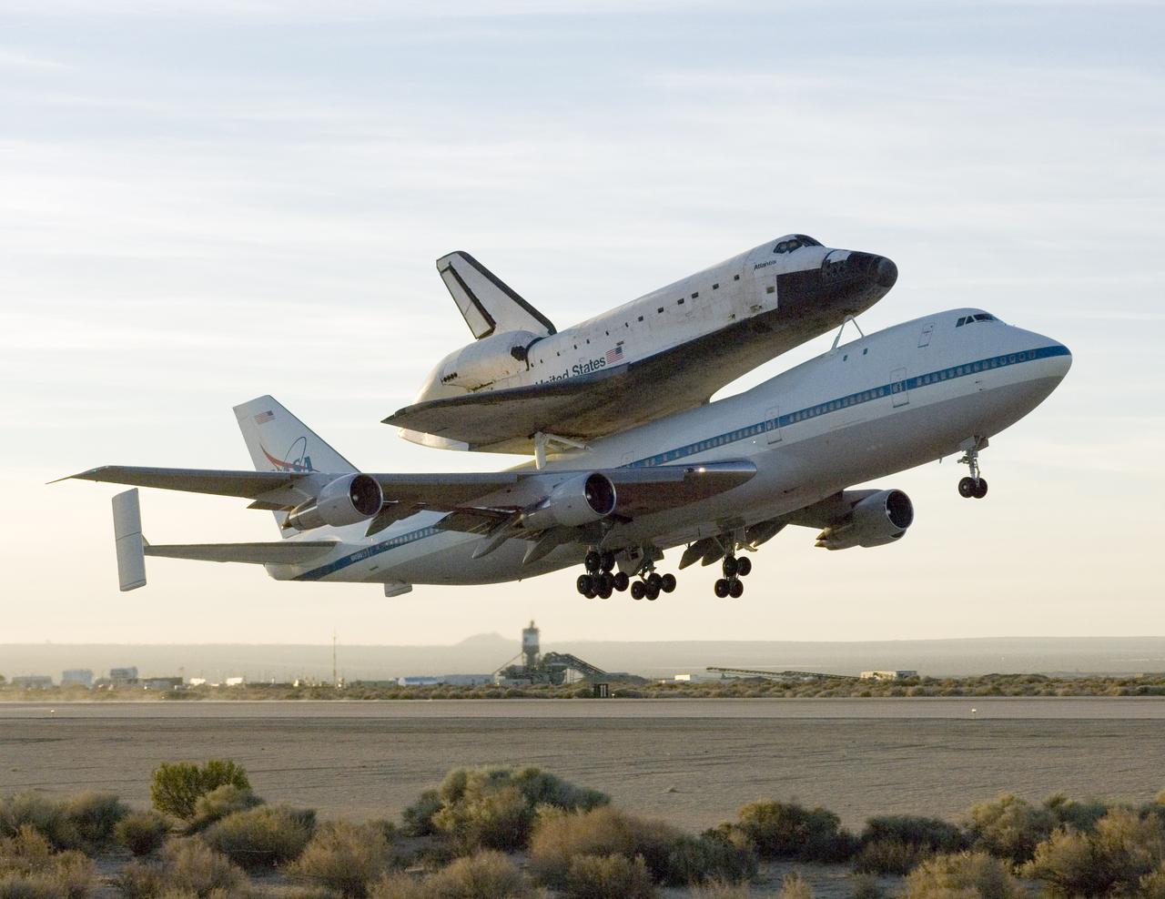 NASA's modified Boeing 747 Shuttle Carrier Aircraft with the Space Shuttle Atlantis on top lifts off from Edwards Air Force Base to begin its ferry flight back to the Kennedy Space Center in Florida. The cross-country journey will take approximately two days, with stops at several intermediate points for refueling.