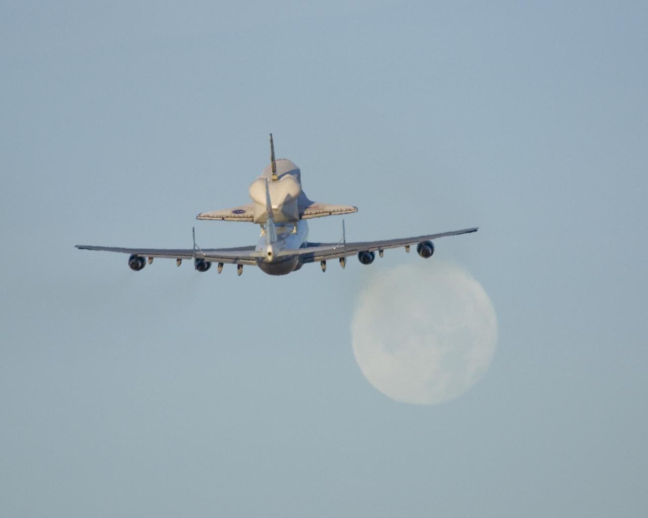 NASA's modified Boeing 747 Shuttle Carrier Aircraft with the Space Shuttle Atlantis on top lifts off from Edwards Air Force Base to begin its ferry flight back to the Kennedy Space Center in Florida. The cross-country journey will take approximately two days, with stops at several intermediate points for refueling.