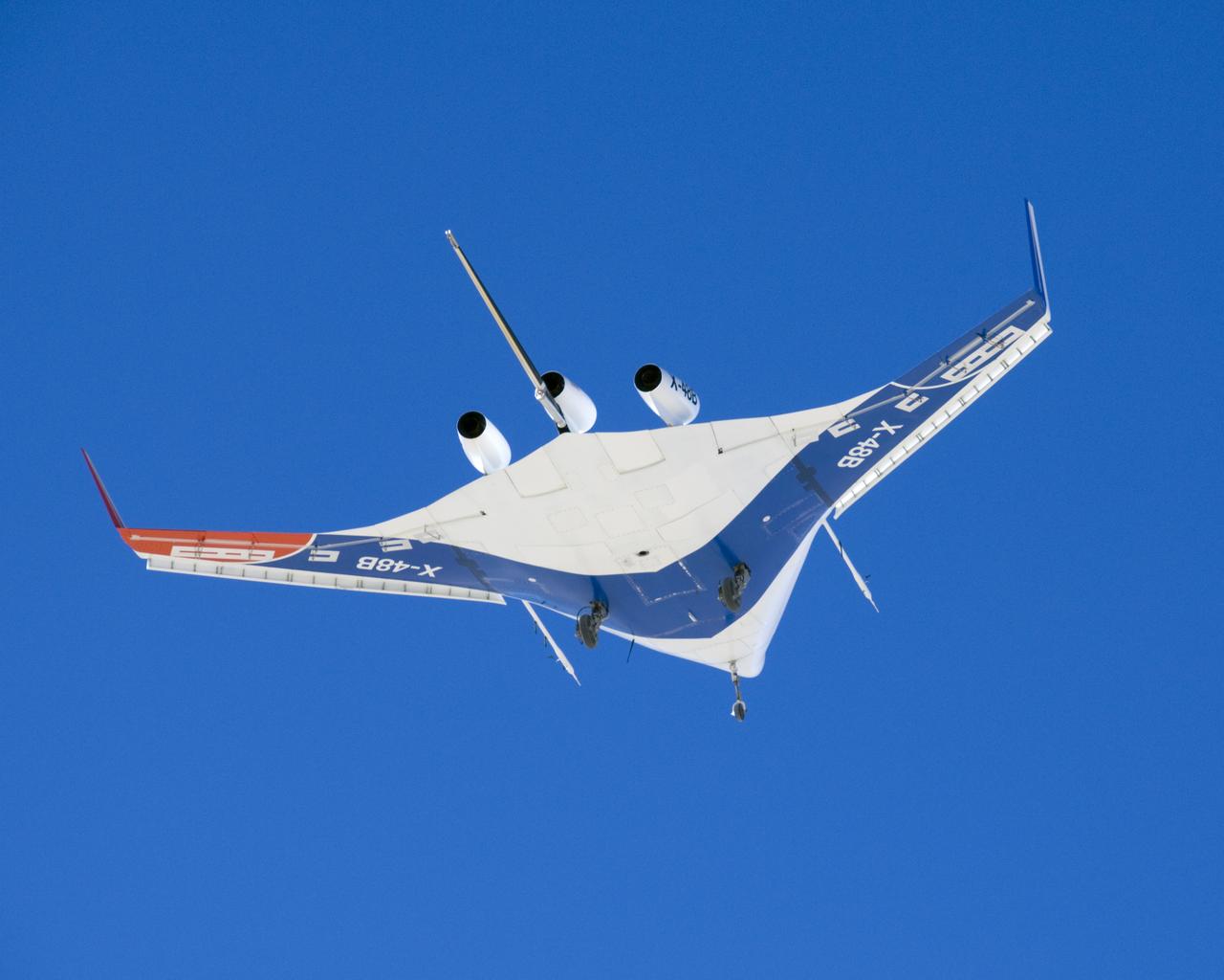 A pristine blue sky backdrops the X-48B Blended Wing Body aircraft during the aircraft's first flight July 20, 2007, from NASA's Dryden Flight Research Center.