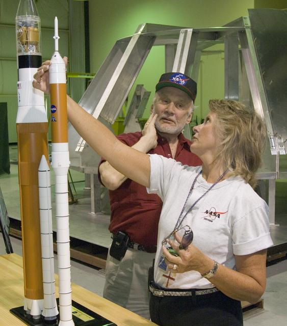 NASA image: Apollo 11 astronaut Buzz Aldrin and tour guide Mary Ann Harness check out models of the Ares 1 and Ares 5 space vehicles during Aldrin's tour of NASA Dryden