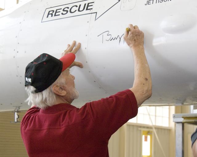NASA image: Apollo 11 astronaut Buzz Aldrin autographs NASA Dryden's F-16XL research aircraft, as his crewmate Neil Armstrong had previously done on the other side