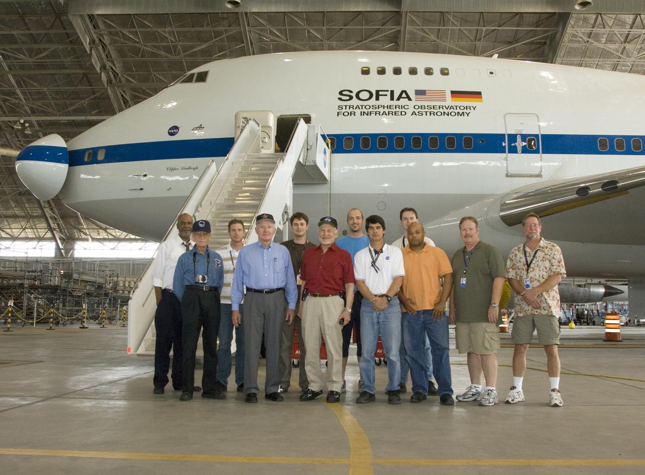 Members of the SOFIA infrared observatory support team gather around Apollo 11 astronaut Buzz Aldrin (in red shirt) during Aldrin's tour of NASA Dryden.