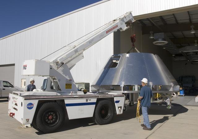 NASA image: A mockup Orion crew module built by NASA Dryden's Fabrication Branch gets a lift from its construction site to its new home in Dryden's Shuttle hangar.