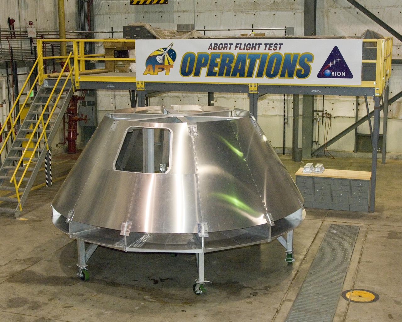 NASA Dryden's mockup Orion crew module is located in Dryden's Shuttle hangar, where abort flight test equipment is being positioned.