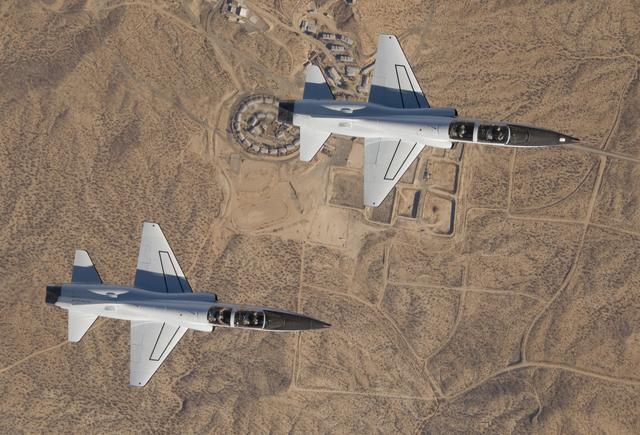 NASA Dryden's two T-38A mission support aircraft fly in tight formation while conducting a pitot-static airspeed calibration check near Edwards Air Force Base