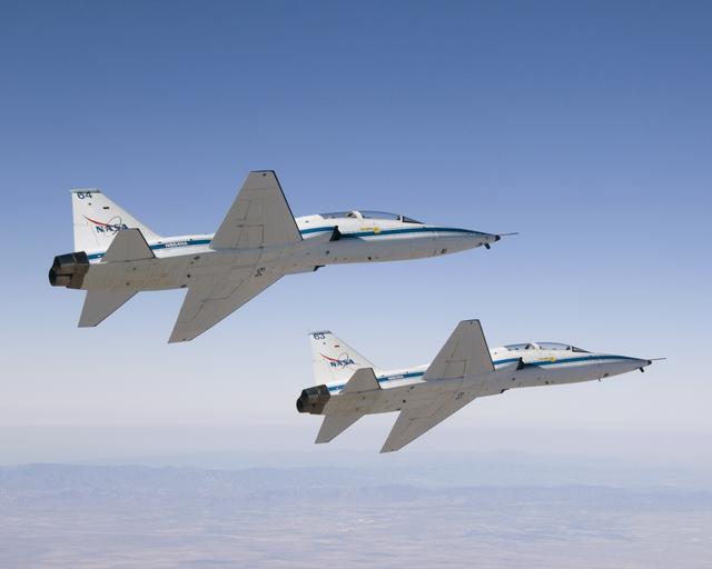 NASA Dryden's two T-38A mission support aircraft fly in tight formation while conducting a pitot-static airspeed calibration check near Edwards Air Force Base