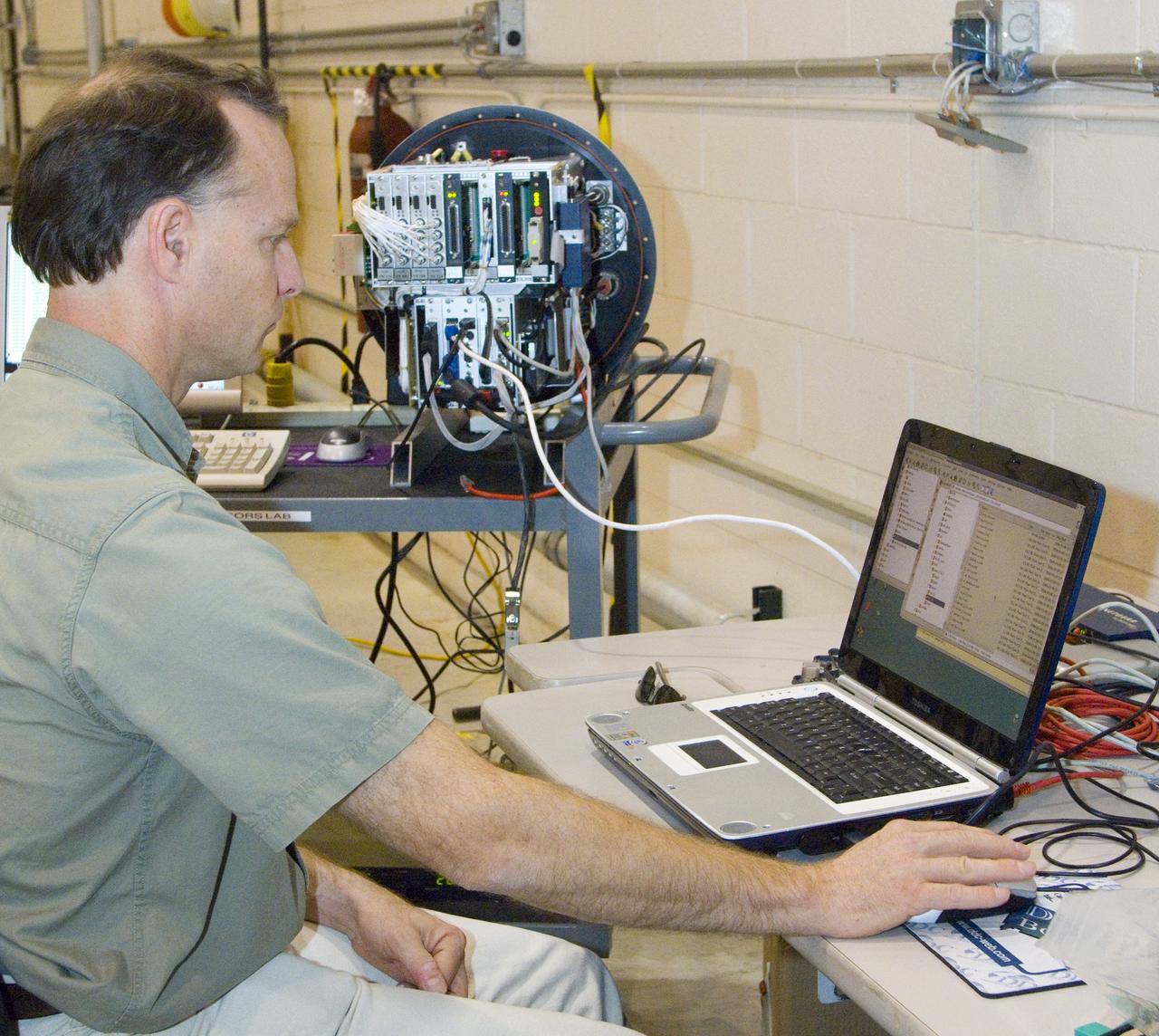 NASA Ames engineer Ted Hildum checks out the thermal-infrared scanner computer before it is loaded on NASA's Ikhana unmanned aircraft.