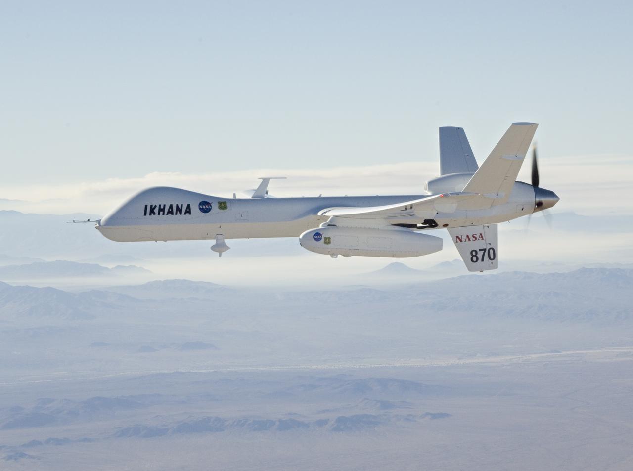 With smoke from the Lake Arrowhead area fires streaming in the background, NASA's Ikhana unmanned aircraft heads out on a Southern California wildfires imaging mission.