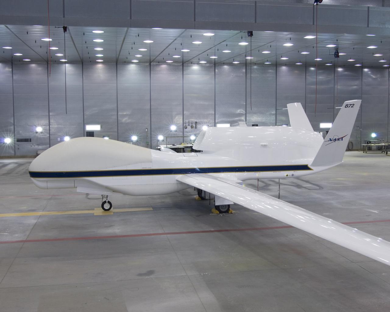One of NASA's two Global Hawk unmanned aircraft shows off its new blue-and-white livery shortly after being repainted in the Edwards Air Force Base paint hangar.