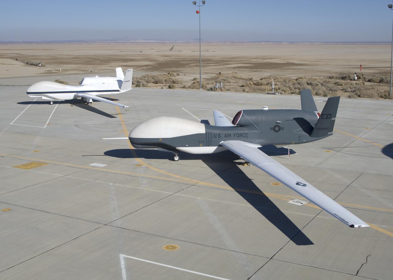 NASA's two Global Hawks, one sporting a NASA paint scheme, the other in its prior Air Force livery, are shown on the ramp at the Dryden Flight Research Center.