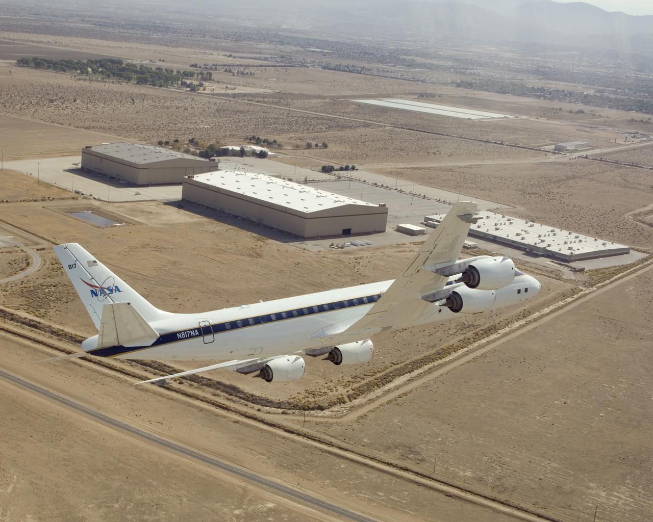 NASA's DC-8 airborne science laboratory banks low over the Dryden Aircraft Operations Facility at Air Force Plant 42 in Palmdale, Calif., upon arrival November 8, 2007.